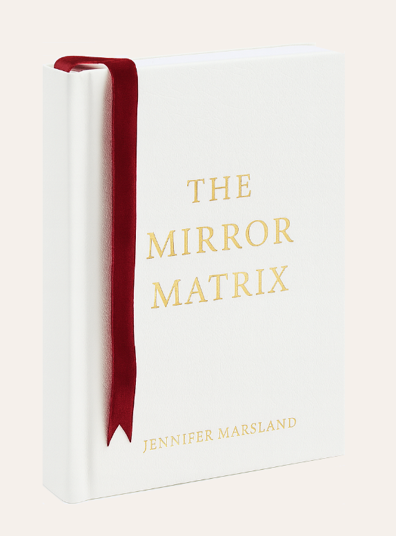 The Mirror Matrix by Jennifer Marsland — white hardcover book with gold lettering and deep red ribbon bookmark